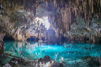 Inside a cenote with clear blue lake