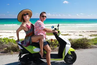 Couple on a scooter near the beach